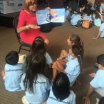 Sonia Lopez reading to the group of children from Treasure Island and CNC- Early Childcare Center.